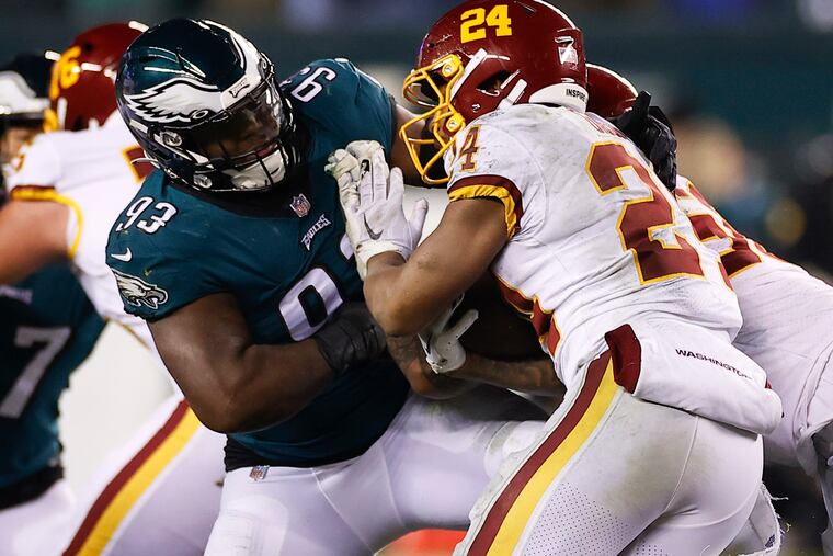 Eagles defensive end Milton Williams stops Washington Football Team running back Antonio Gibson during the teams' first meeting of the year on Dec. 21.