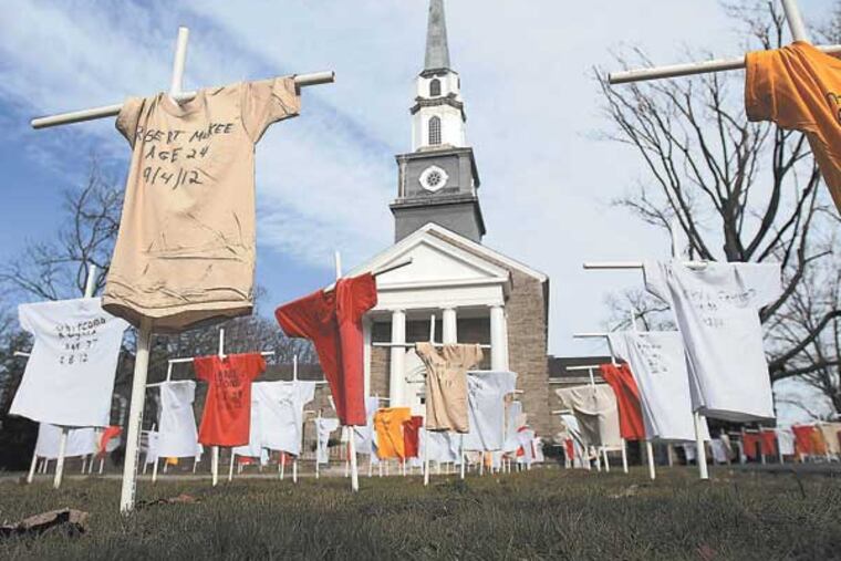 A memorial to last year's homicide victims lost to gun violence is on display in front of the Chestnut Hill Presbyterian Church in Philadelphia, Pa., on January 20, 2013. Each shirt represents a victim. ( DAVID MAIALETTI / Staff Photographer )