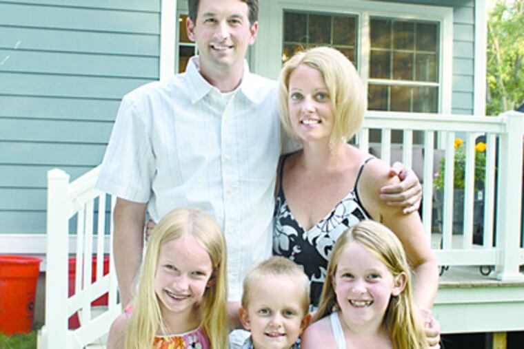 The Hoffs — Rick and Kathy and their children (from left) Hannah, Kevin, and Julia — in front of their new home in Haddonfield. (Ed Hille / Staff photographer)