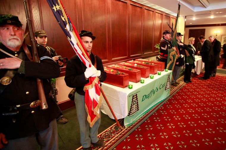 Members of the 69th Pennsylvania Irish Brigade stand posted with the five coffins before the remains were given a full Christian burial at West Laurel Hill Cemetery. They had been buried in Chester County.
