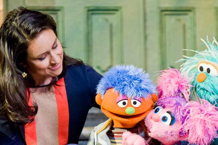 Alex (second from left), a Sesame Street character whose father is incarcerated, gets comforted by friends. A new Sesame Street initiative aims to help children of incarcerated parents cope, and provide resources for guardians.