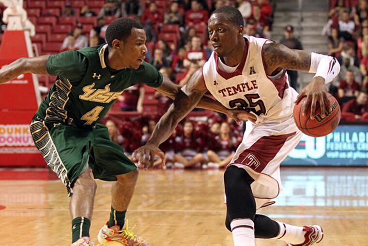 Temple's Quenton DeCosey dribbles the ball against South Florida's Corey Allen during the second half. (Yong Kim/Staff Photographer)