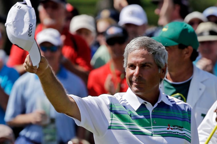Fred Couples tips his cap after a birdie on the 18th green during the second round of the Masters golf tournament Friday, April 12, 2013, in Augusta, Ga. (David J. Phillip/AP)