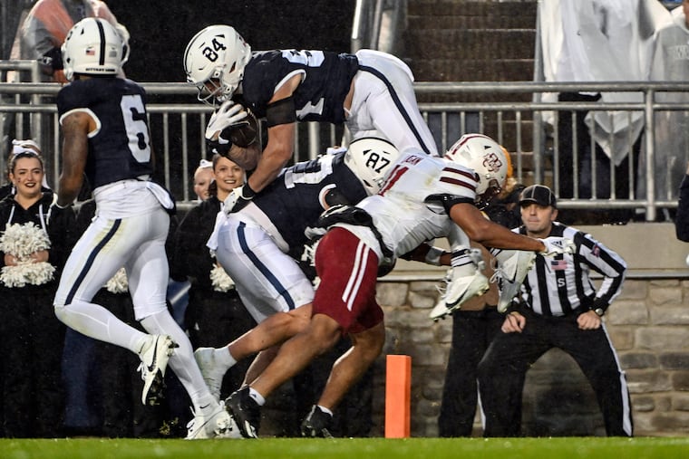 Penn State tight end Theo Johnson (84) scores a touchdown during the second half of the Nittany Lions' 63-0 blowout against Massachusetts on Saturday.