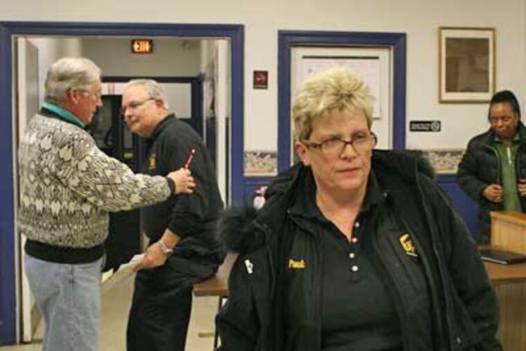 Paula Brown (center), an ex-mayor with eyes to run again, and Police Chief Robert Smythe (second from left) in January. As far back as 1999, Smythe had racked up $125,000 in comp time. (Daily News file photo)