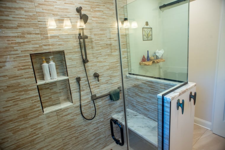 The bathroom of Mary Riker, built when she decided to downsize and construct an addition to her home. She now lives in the addition, and her family lives in the main house. The bathroom features a grab bar, a shower bench, and other accessibility features.