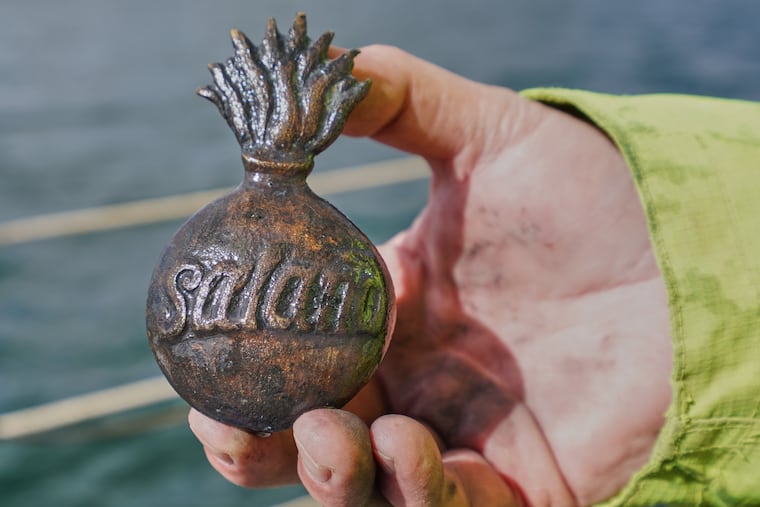 Morten Johansen, head of maritime archaeology at Denmark's Viking Ship Museum, shows a metal insignia recovered from the wreck of Danish flagship "Dannebroge" that sank during the Battle of Copenhagen in 1801.