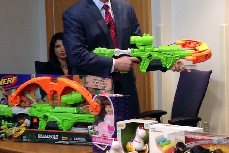James Swartz, director of World Against Toys Causing Harm, or WATCH, displays Nerf's "Zombie Strike" crossbow.