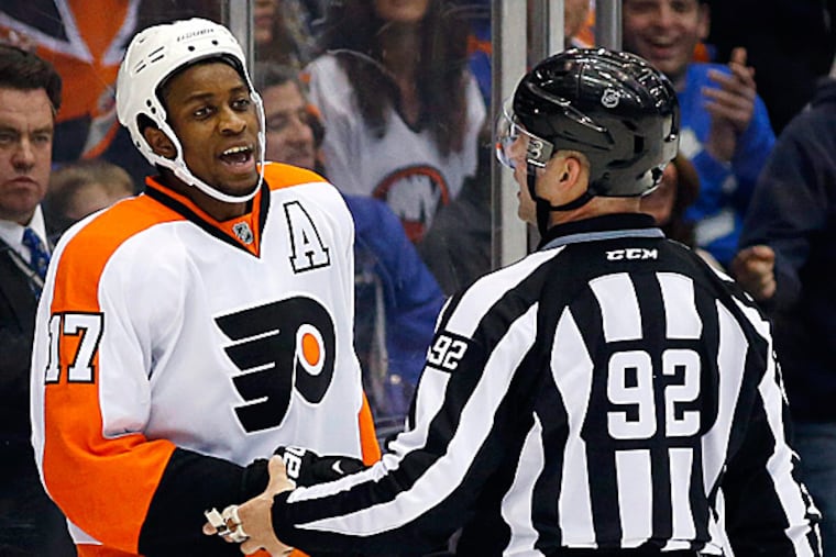 Flyers right wing Wayne Simmonds yells at a referee as linesman Mark Shewchyk restrains him. (Kathy Willens/AP)