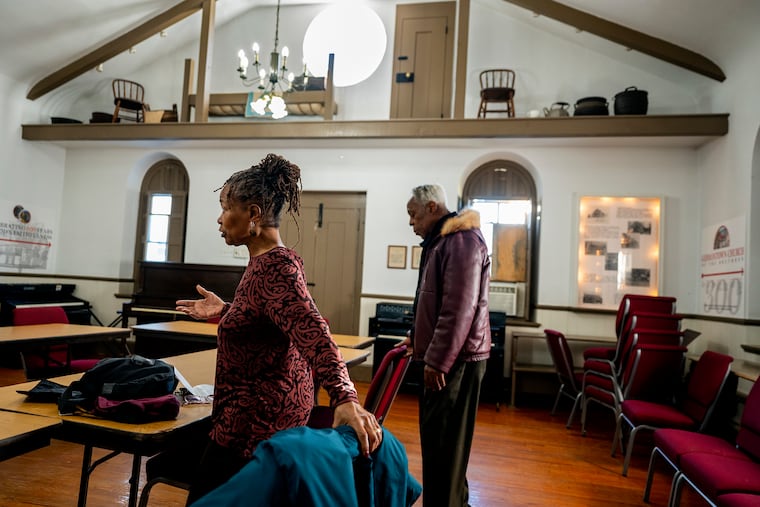 Cheryl Jensen-Gates and the Rev. Joseph Craddock (right) pause to pray at the Germantown Church of the Brethren.