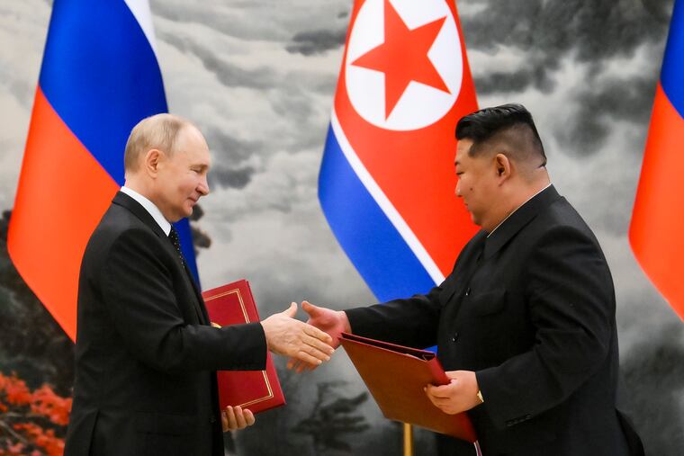 Russian President Vladimir Putin (left) and North Korean leader Kim Jong Un exchange documents during a signing ceremony of their new partnership in Pyongyang, North Korea, on Wednesday.