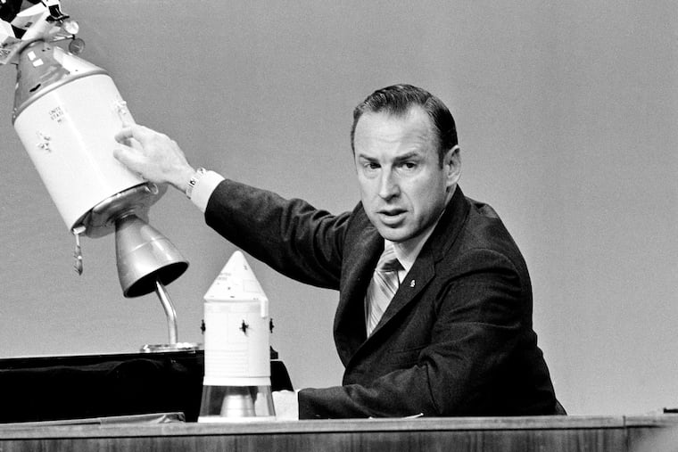 FILE - Apollo 13 commander James A. Lovell speaks during a televised news conference at the Manned Spacecraft Center in Houston, Texas, April 21, 1970, pointing to the spot on the service module where an explosion ripped a panel loose.