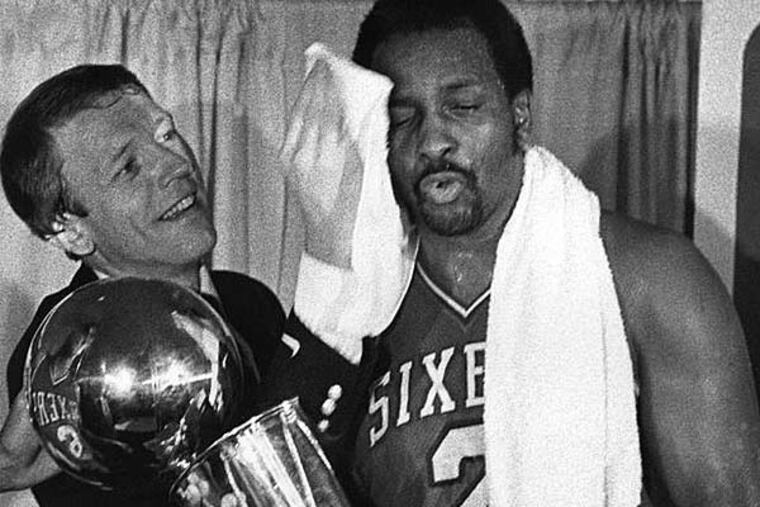Sixers coach Billy Cunningham wipes Moses Malone's brow during 1983 NBA championship celebration. (George Reynolds/Daily News file photo)