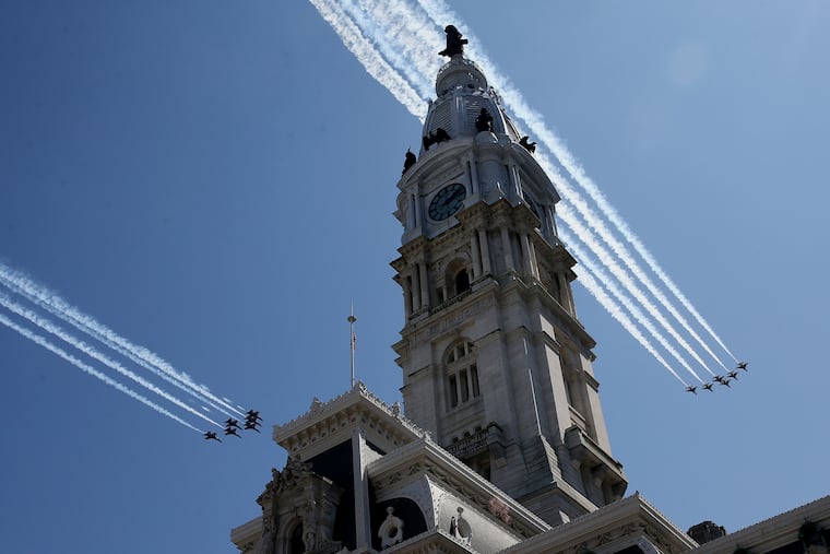 The U.S. Navy Blue Angels (left) and U.S. Air Force Thunderbirds flight demonstration squads perform a flyover in honor of health-care workers across City Hall in Philadelphia on Tuesday, April 28, 2020. The flyover was one of a number of similar events planned across the country in response to the coronavirus pandemic.