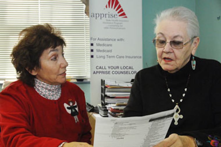 Bette Ferrill (left), 67, of Havertown listens to prescription options available to her from Apprise coordinator Kim Andrews at the Friendship Circle Senior Center in Darby.