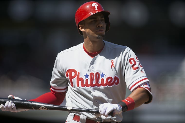 Aaron Altherr walks back to the dugout after striking out for the fourth time during the Phillies' 6-1 loss on Sunday.