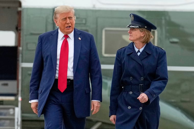 President Donald Trump, left, escorted by Air Force Col. Angela F. Ochoa, Commander, 89th Airlift Wing, walks from Marine One to board Air Force One, Sunday, June 15, 2025, at Joint Base Andrews, Md., for a trip to Canada to attend the G7 Summit.