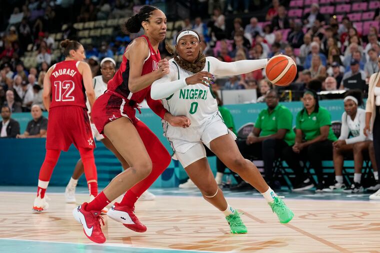 Amy Okonkwo of Nigeria drives on the United States' A'ja Wilson during the quarterfinal game at Bercy Arena in Paris.