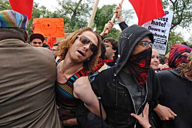 In Philadelphia, Keystone State Skinheads meet counter-protesters when they attempt to hold their annual rally to honor Leif Erickson on Oct. 19, 2013. Here, civil affairs police officers try to keep the counter-protesters away from the skinheads. ( APRIL SAUL / Staff )