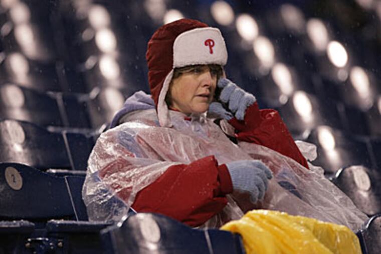 A fan as Game 5 of the World Series between the Philadelphia Phillies and the Tampa Bay Rays was suspended due to rain. (Yong Kim / Philadelphia Daily News)