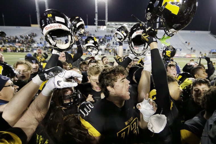 Archbishop Wood players celebrate after the team won the PIAA Class 5A state football championship Friday night.