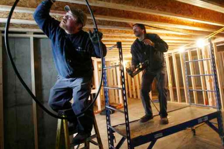 Construction boom? Jeff Rose (left) and Wayne Green of Gillespie Fuels install a heating system in Vermont. Improved weather in November helped new-home construction rebound.