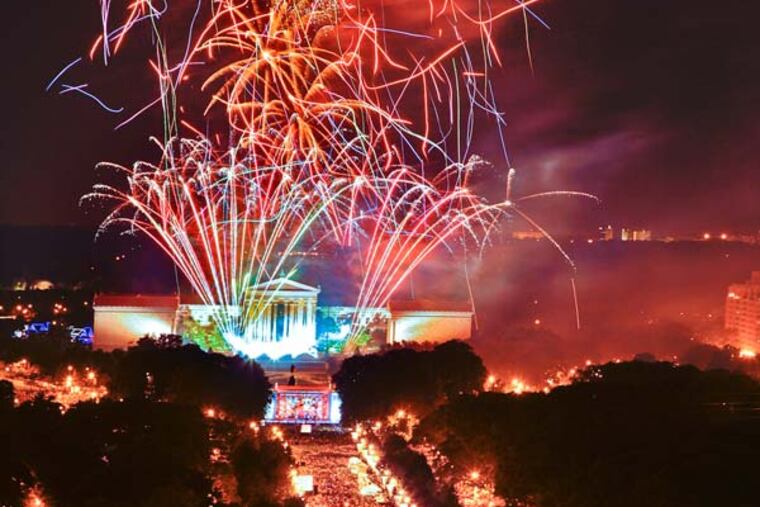 Fireworks explode over the Philadelphia Museum of Art, top, in Philadelphia, as thousands line the Benjamin Franklin Parkway.(AP Photo/George Widman, Greater Phila. Tourism M.C.)