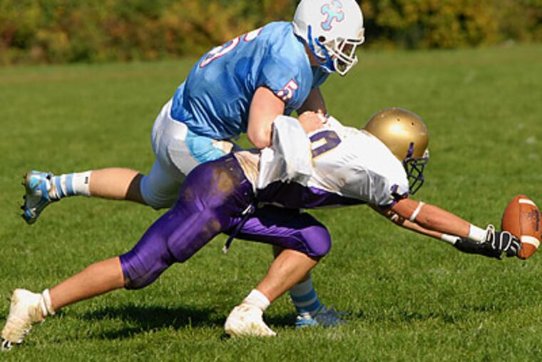 Father Judge senior Adam Nowak (rear) was a two-way terror this season, starring at strong saftey and wide receiver. (Peter Tobia / Staff Photographer)