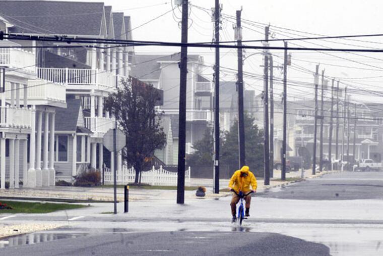 A cyclist rides through the flooded streets of Sea Isle City in this file photo. Minor flooding is expected at the Shore Wednesday.