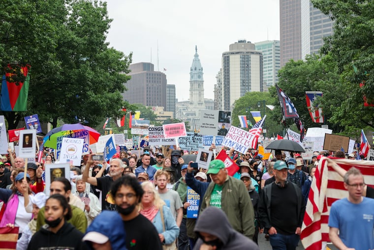 Thousands of protesters march up the Benjamin Franklin Parkway as part of a “No Kings” demonstration in Philadelphia.