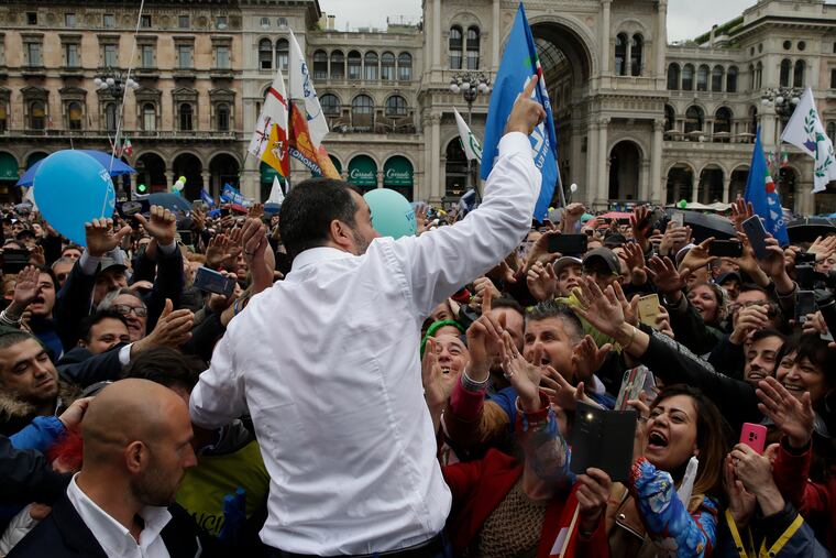 Supporters reach out to Lega leader Matteo Salvini during a rally in Milan, ahead of the European parliamentary elections.