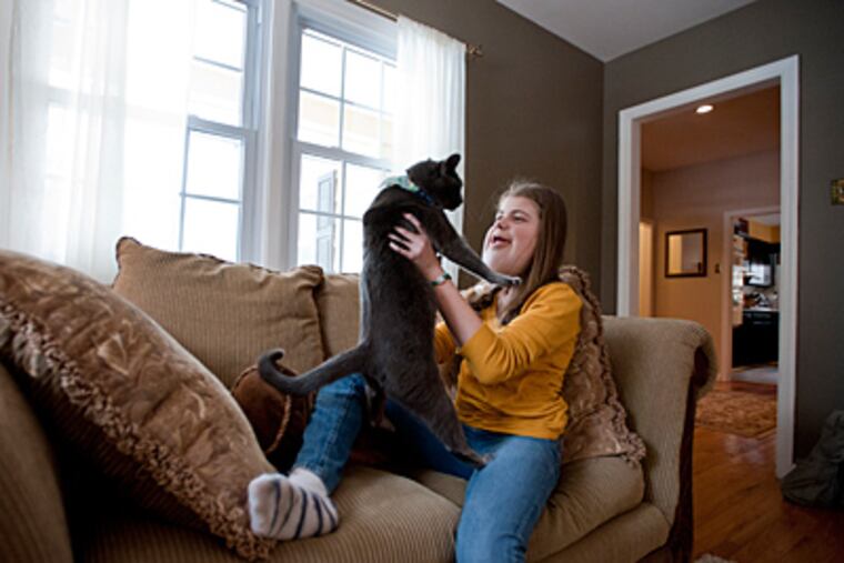 Kennedy Hubbard, 13, was born with a rare condition called Lymphatic
Vascular Malformation. At home in Moorestown she plays with her cat
Giacamo. ( Sharon Gekoski-Kimmel / Staff Photographer