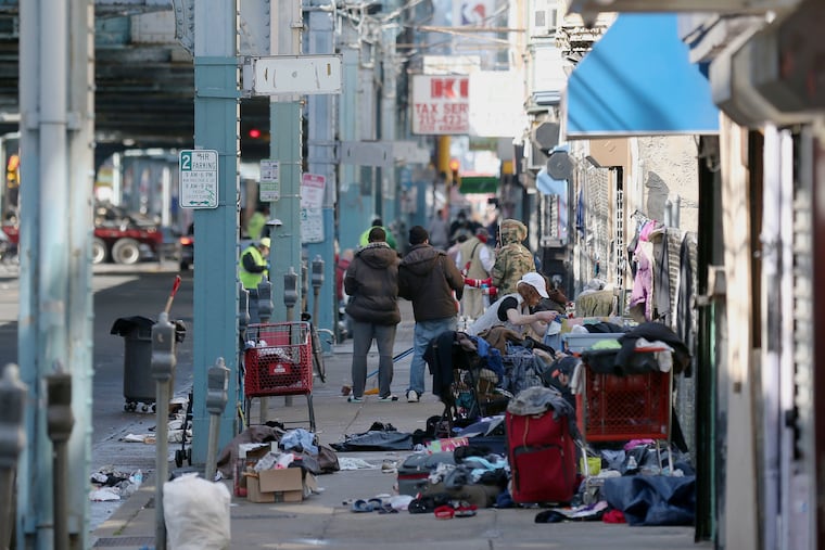 People gathering on the sidewalk along Kensington Avenue in Philadelphia's Kensington section on Thursday. For some along the avenue — such as those struggling with opioid addiction and homelessness — social distancing during the coronavirus pandemic is difficult or impractical.