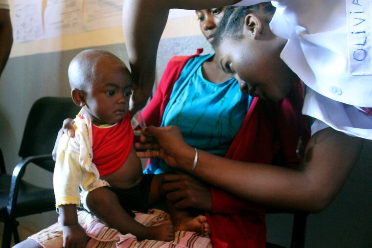 In this photo taken on Thursday, March 21, 2019, a volunteer nurse examines 6-moth-old Sarobidy, who is infected with measles, while her mother Nifaliana Razaijafisoa looks on, at a healthcare centre in Larintsena, Madagascar. As the island nation faces its largest measles outbreak in history and cases soar well beyond 115,000, the problem is not centered on whether to vaccinate children. Many parents would like to do so but face immense challenges including the lack of resources and information.
