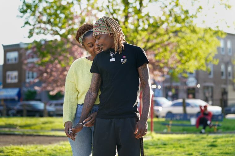 Fharen Thornton, left, and Justin Alexander, right, enjoy the warm weather at Malcolm X park, at 52nd and Pine Streets, in West Philadelphia, April 20, 2021.