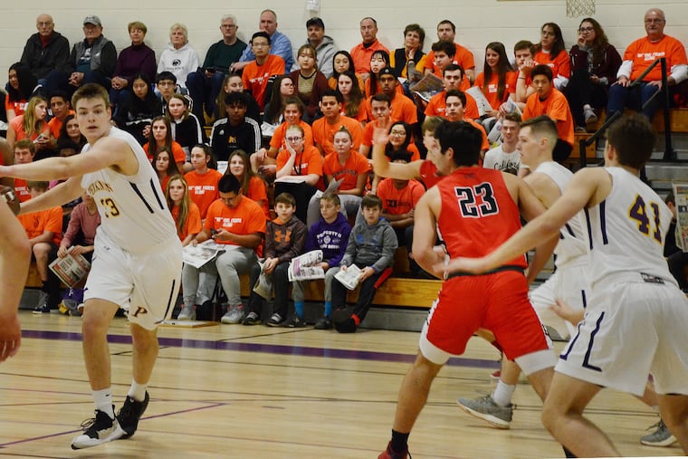 Students at the Perkiomen School wear their "Orangeout" T-shirts while watching the boys' basketball team play Lawrenceville on Friday.