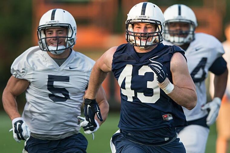 Penn State linebacker Mike Hull smiles while running sprints during football practice Wednesday, Oct. 1, 2014 in State College, Pa. (AP Photo/PennLive.com, Joe Hermitt)
