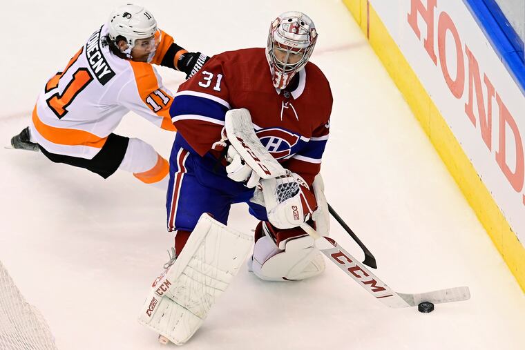 Flyers right winger Travis Konecny (11) looking for an opportunity as Montreal Canadiens goaltender Carey Price cleared the puck from behind the net during the second period of Game 3 on Sunday. The Flyers won, 1-0, to take a 2-1 series lead.