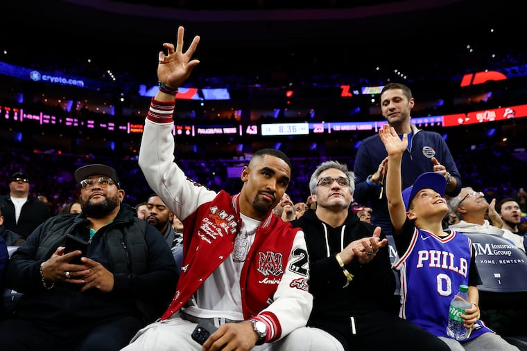 Eagles quarterback Jalen Hurts acknowledges fans attending the Sixers game against the Los Angeles Lakers on Monday, November 27, 2023 in Philadelphia.