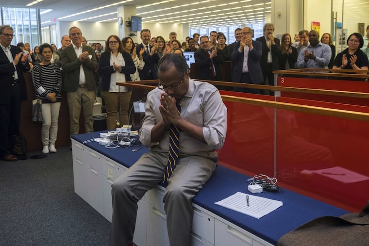 Brent Staples, a member of the New York Times editorial board, and a native of Chester, Pa., reacts as the newsroom applauds him upon the announcement that he'd won the Pulitzer Prize for editorial writing on April 15, 2019.