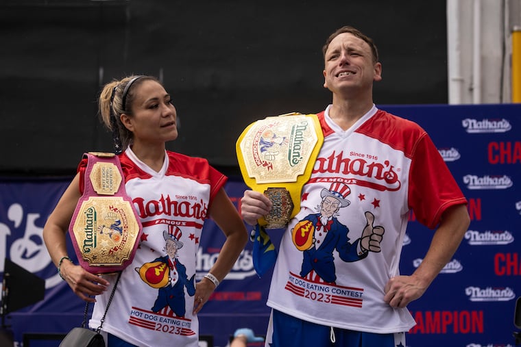 This year's woman's champion Miki Sudo, left, and man's champion Joey Chestnut, right, stand together during the 2023 Nathan's Famous Fourth of July hot dog eating contest in the Coney Island section of the Brooklyn borough of New York, Tuesday, July. 4, 2023.