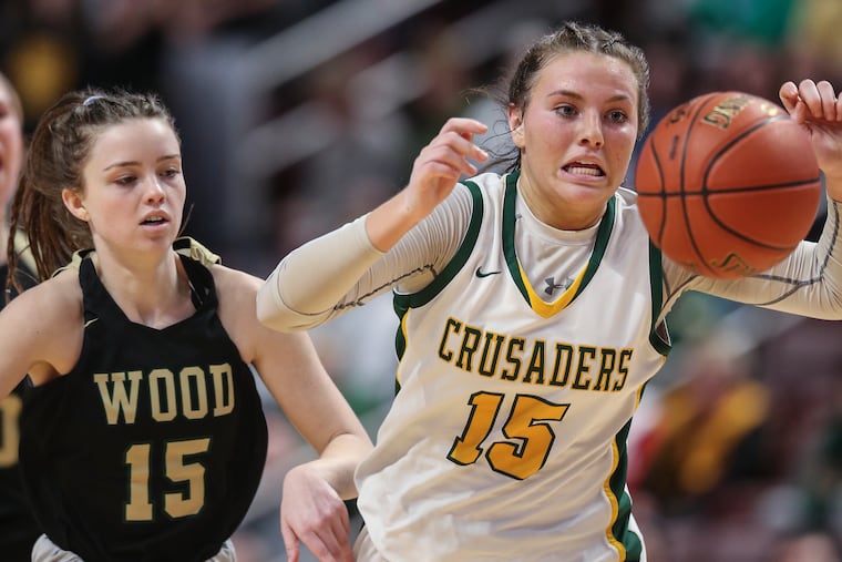 Archbishop Wood Allie Fleming and Lansdale Catholic Gabby Casey chase a loose ball during the 4th quarter of the PIAA 4a District XII Championship at the The Giant Center in Hershey, Thursday, March 24, 2022. Wood beats Lansdale Catholic 57-45 for the State Championship.