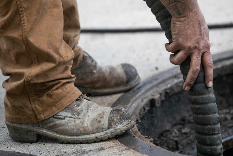 Crews clean up after a gasoline spill from Gas ‘N’ Go at the corner of Coebourn Boulevard and Edgmont Avenue in Brookhaven in June. Almost 5,000 gallons permeated the ground at Coebourn Elementary School next door to the gas station, and flowed into the retention pond.