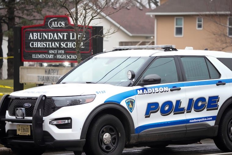 Emergency vehicles are parked outside the Abundant Life Christian School in Madison, Wis., on Monday after a 15-year-old shot and killed two people before taking her own life.
