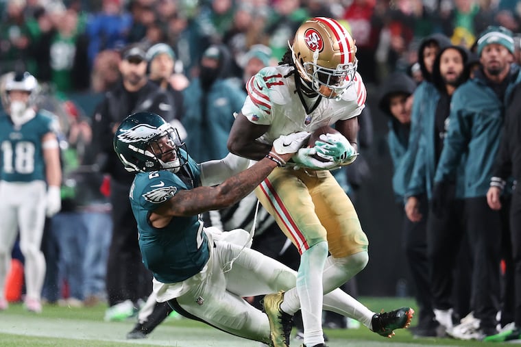 San Francisco 49ers wide receiver Brandon Aiyuk runs with the football past Eagles cornerback Darius Slay in the third quarter on Sunday, December 3, 2023 in Philadelphia.