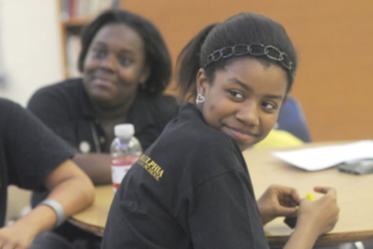 KIPP West Philadelphia students Brianna Phipps (front), 12, and Chanell Johnson, 12, are in the leadership program. (April Saul / Staff Photographer)