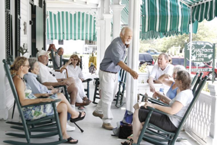 Bob Mullock greets guests enjoying the Chalfonte's wraparound porch. He and his wife, Linda, bought the hotel in 2008. (Elizabeth Robertson / Staff Photographer)