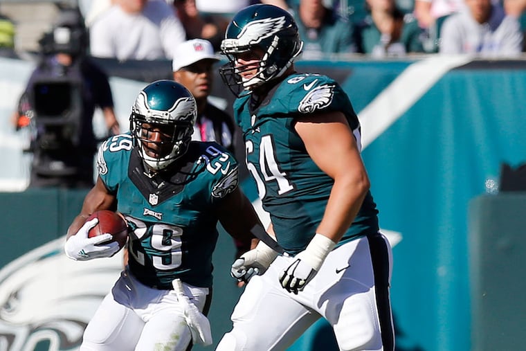 DeMarco Murray runs with the football as Matt Tobin looks for a block.