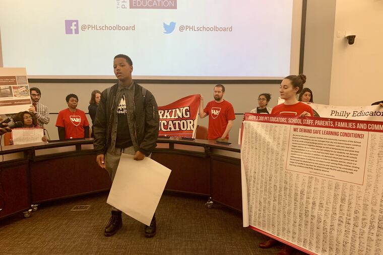 Student Charles Mitchell speaks after activists angry about a vote to mandate metal detectors disrupt the Philadelphia school board meeting. The school board left the room and members of the “people’s school board†began speaking.
