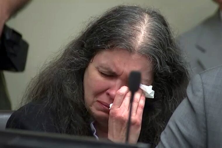 In this photo from video by KABC-TV, Louise Turpin sobs and dabs her eyes as one of her children speaks during a sentencing hearing Friday, April 19, 2019, in Riverside, Calif. David and Louise Turpin, who pleaded guilty to years of torture and abuse of 12 of their 13 children, have been sentenced to life in prison with possibility of parole after 25 years. (KABC-TV via AP, Pool)